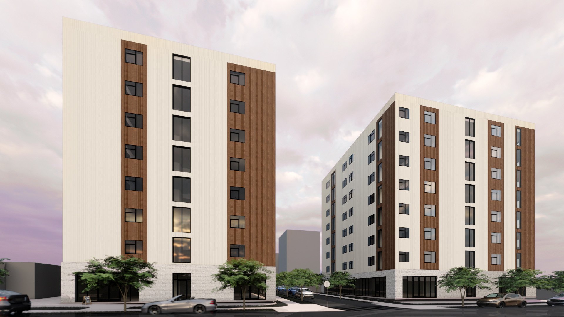 Two modern multi-story residential buildings with white and brown facades, large windows, and a tree-lined street in the foreground during dusk.