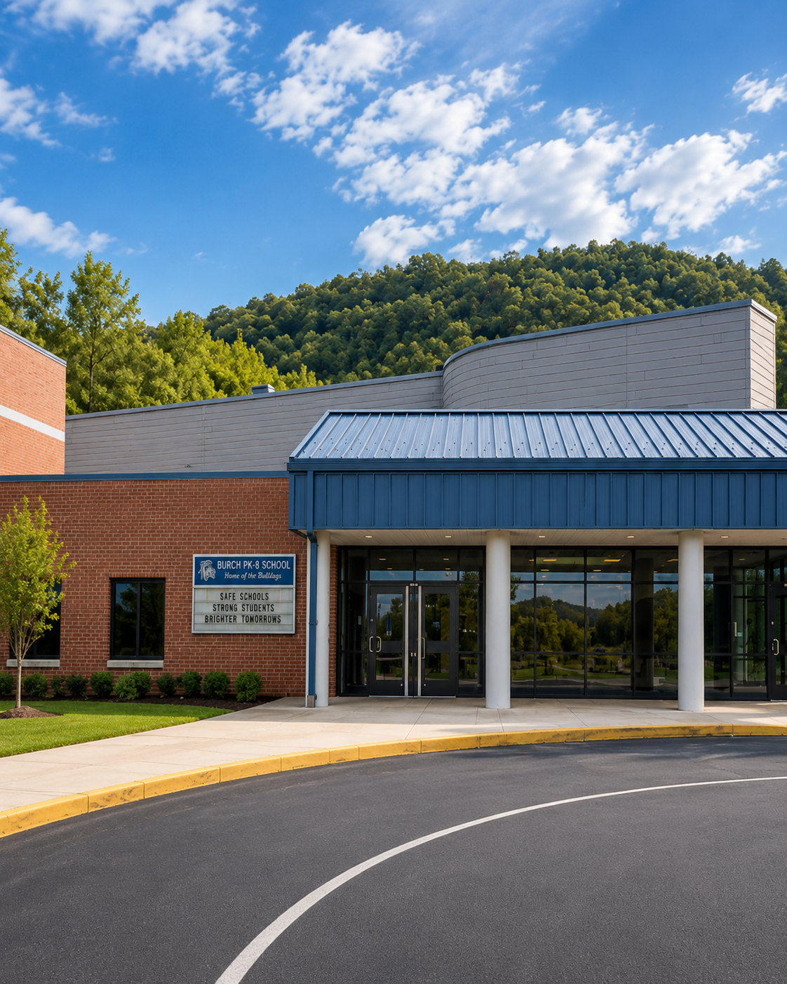 Burch PK-8 School main entrance in Mingo County, West Virginia, with the school facade and Home of the Bulldogs signage.