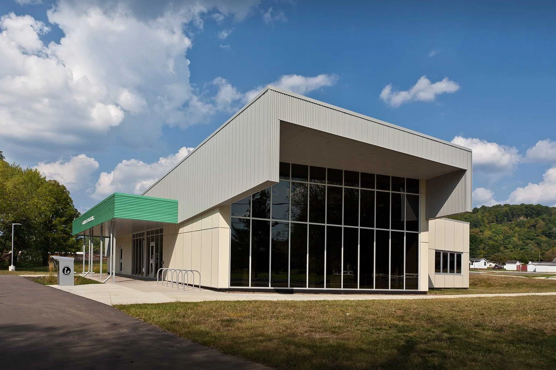 Cox Landing Branch Library exterior with green entrance canopy and glass curtain wall in Huntington, West Virginia.