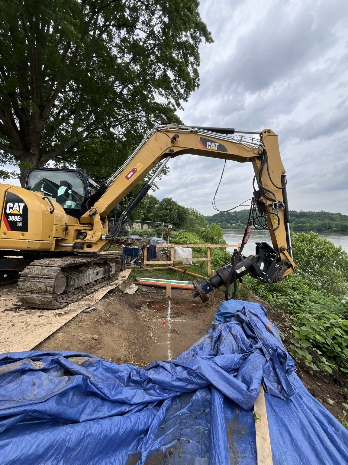 Helical pile installation for riverbank stabilization at the Pallottine Sisters project in Huntington, West Virginia.