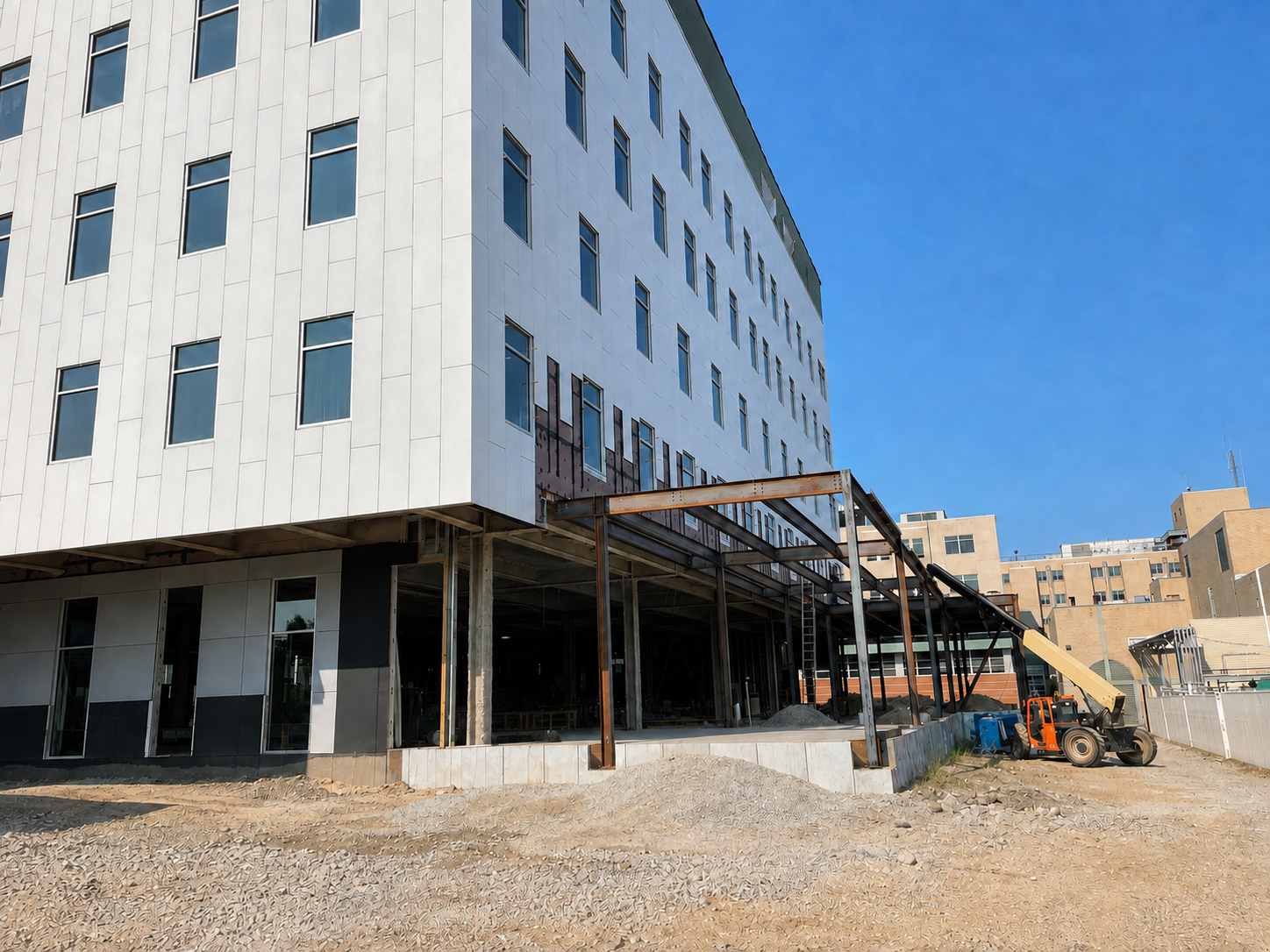 Robert and Lena Shell Medical Pavilion during construction with façade installation and structural steel framing underway.