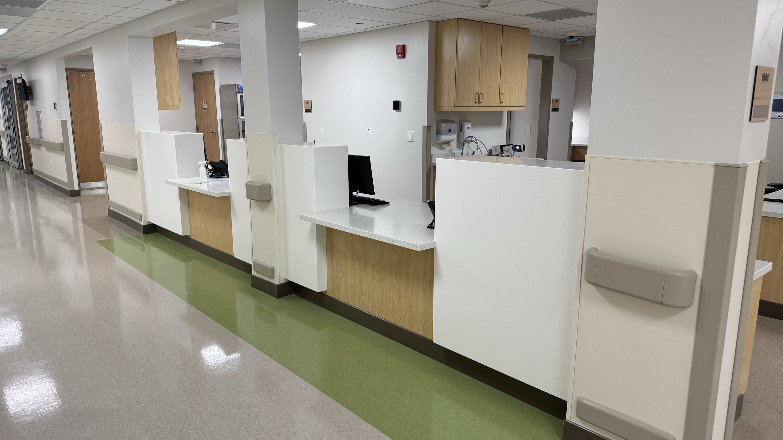 Rivers Health emergency department clinical work area with built-in cabinetry, computer station, wall protection, and medical support space.