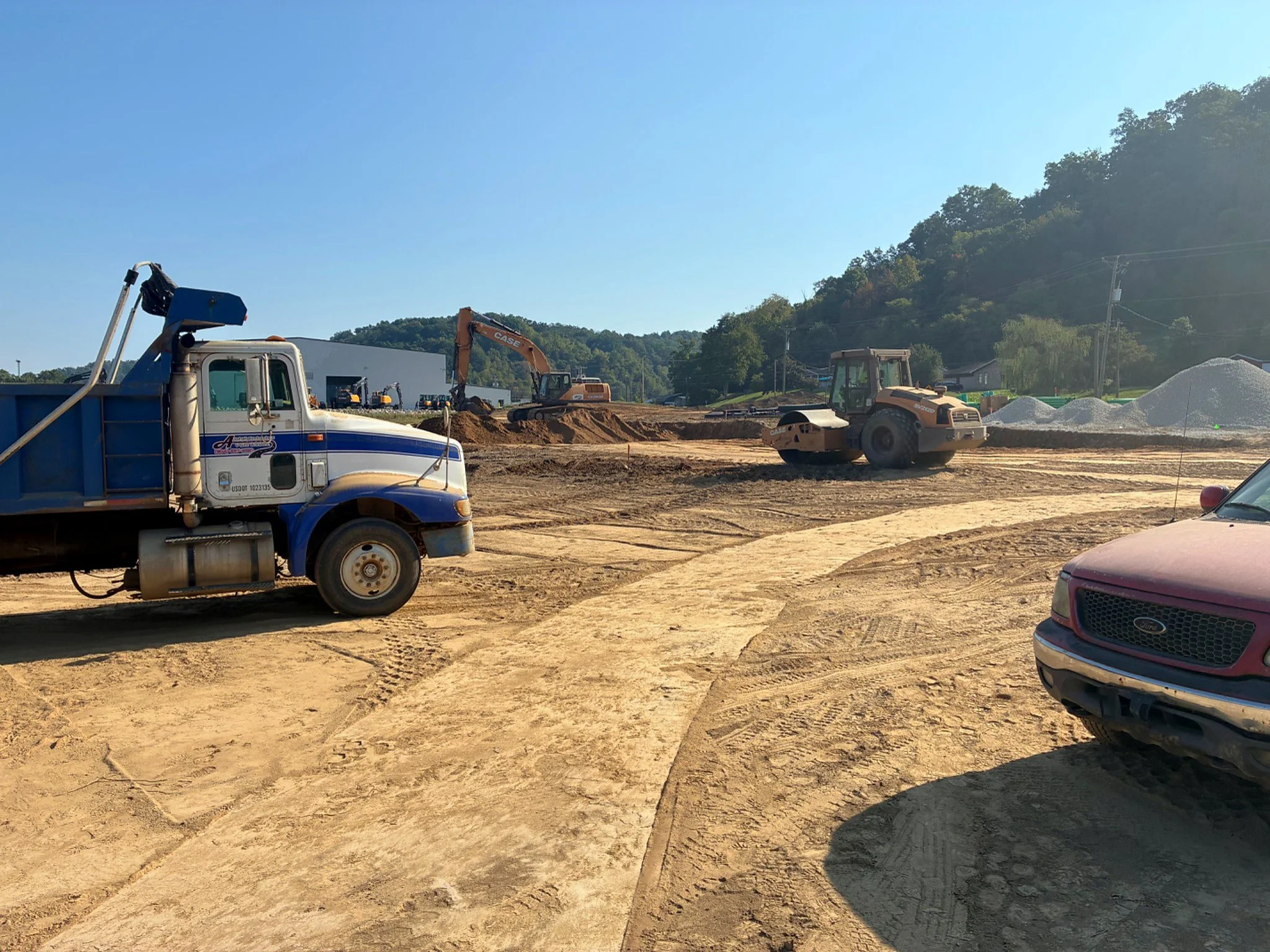 Dump truck, excavator and compaction equipment during grading operations at the Barboursville Healthcare Center in Barboursville, West Virginia.