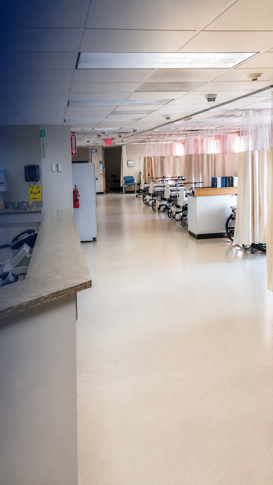Renovated Surgical Eye Center of Morgantown recovery area with privacy curtains, patient bays and nurse station.