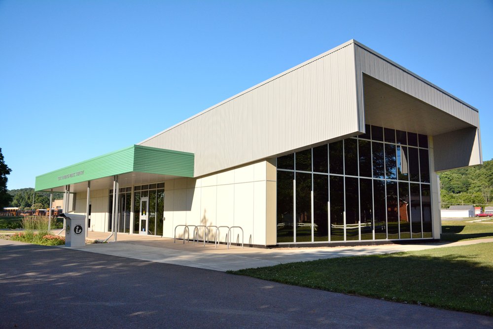 Cox Landing Branch Library exterior with glass curtain wall and green entrance canopy in Huntington, West Virginia.