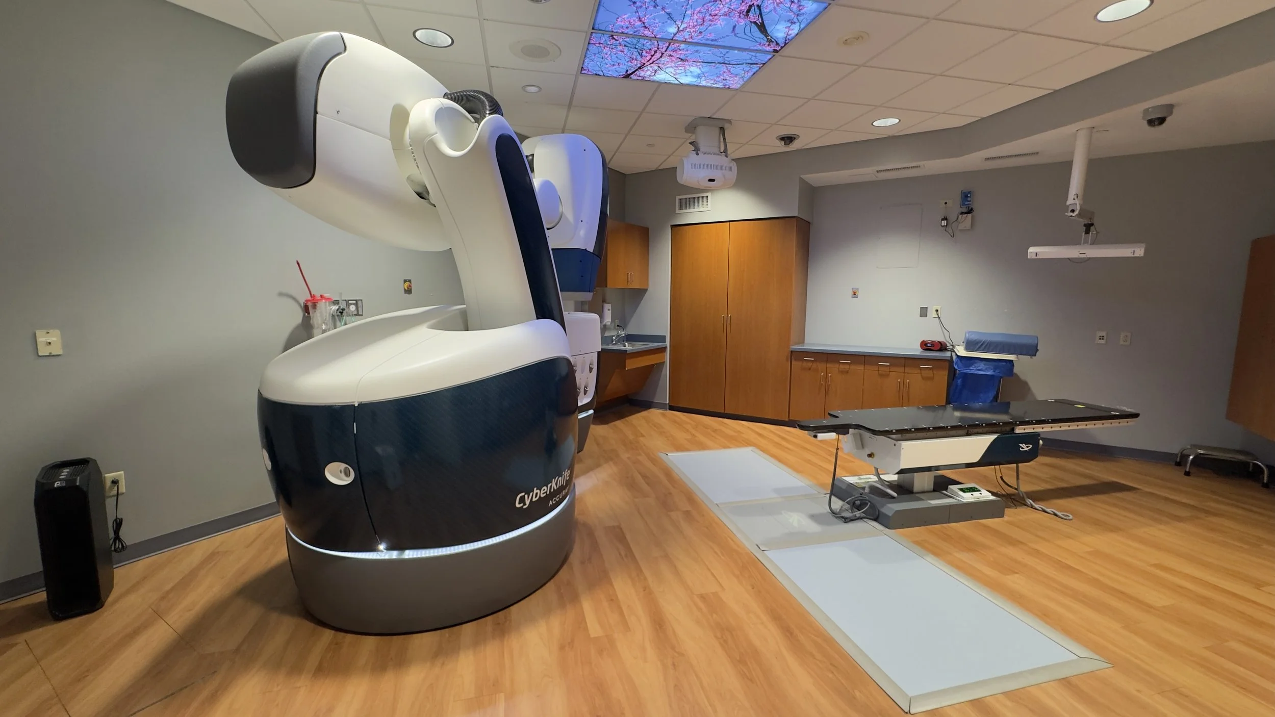 CyberKnife S7 radiation-treatment equipment, treatment table and cabinetry inside the renovated oncology suite.