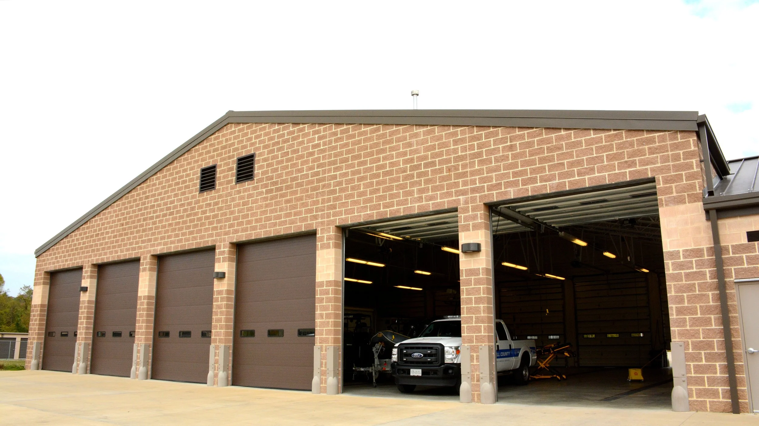 Apparatus bays and emergency vehicles at Cabell County EMS Station 8 in Barboursville, West Virginia.