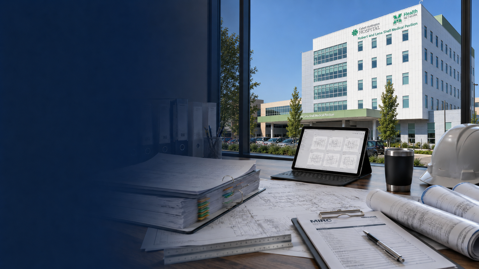 MIRC Planroom workspace with project drawings and construction documents overlooking the Robert and Lena Shell Medical Pavilion at Cabell Huntington Hospital.
