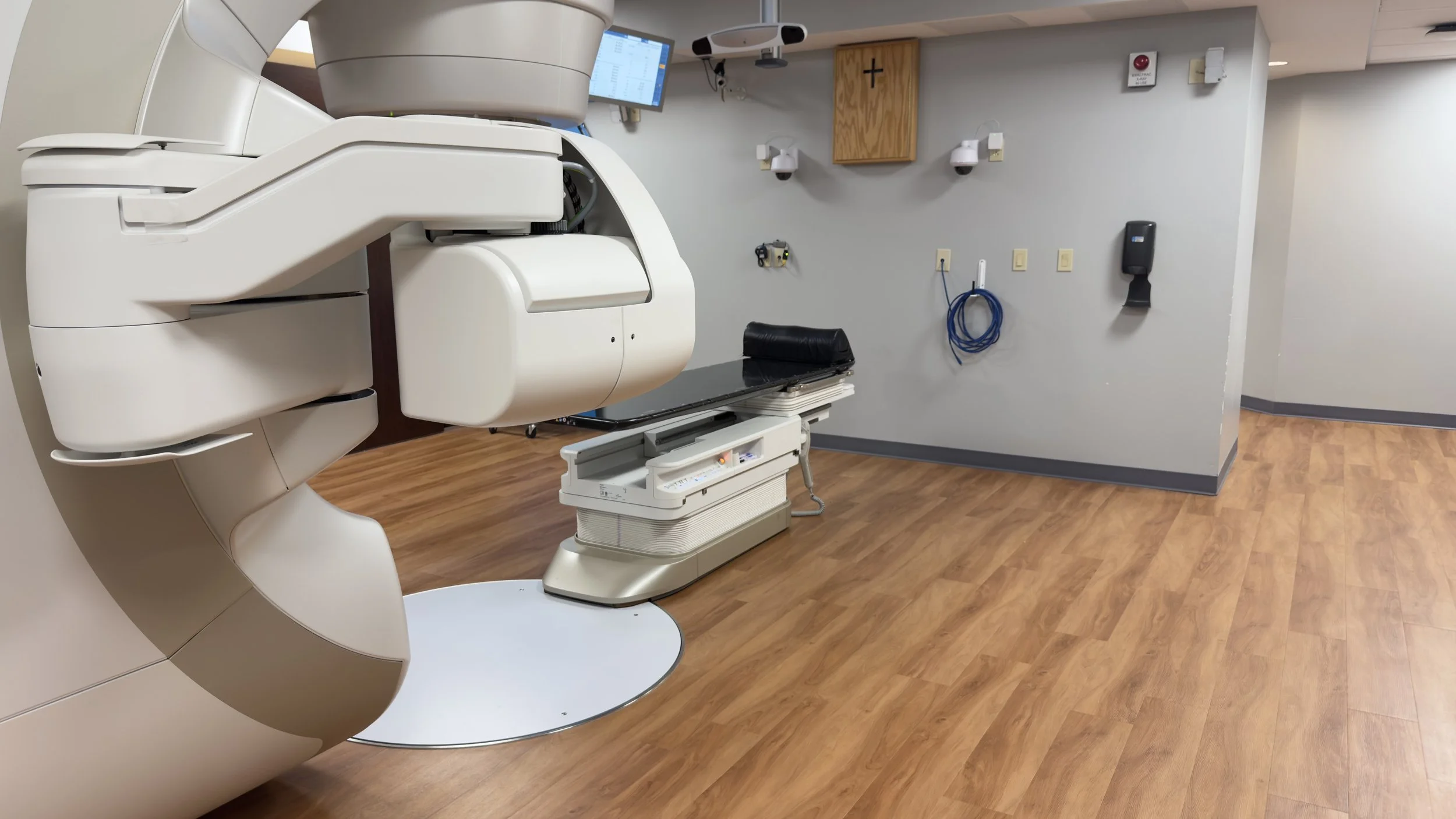 Reverse view of the renovated St. Mary’s TrueBeam treatment room showing the linear accelerator, treatment table and clinical utilities.