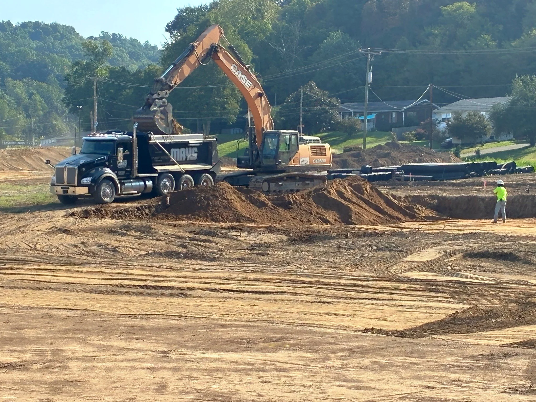 Excavator loading a dump truck during early earthwork at the Barboursville Healthcare Center in Barboursville, West Virginia.