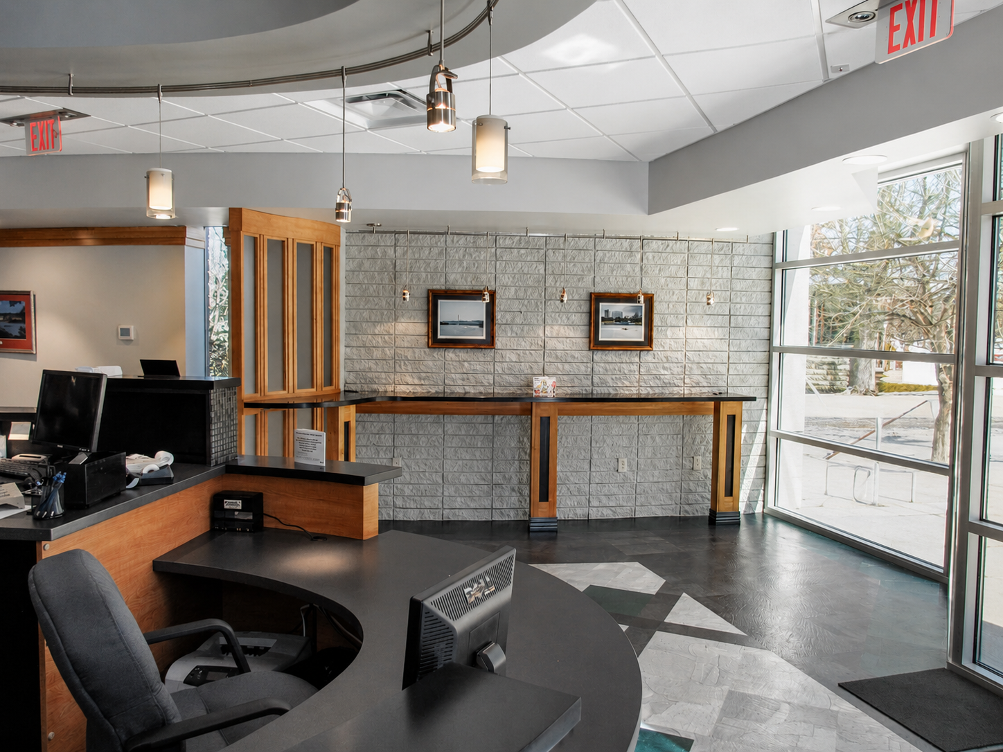 DESCO Federal Credit Union customer service area featuring a stone-front counter, wood countertop and green accent finishes.