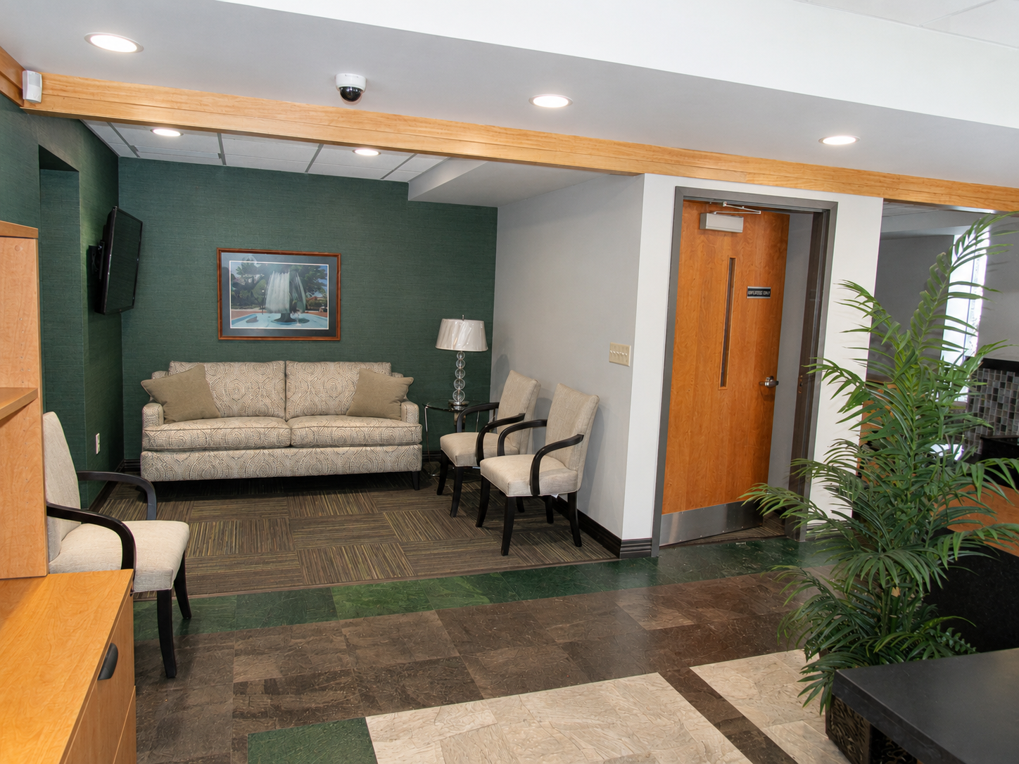 ESCO Federal Credit Union lobby with customer seating, green accent wall, wood finishes and framed artwork.