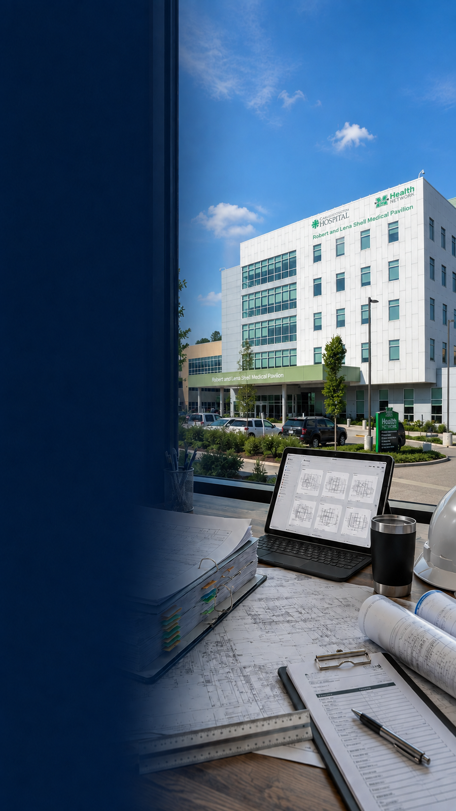MIRC Planroom workspace with construction drawings, laptop, hard hat, and the Robert and Lena Shell Medical Pavilion in the background.