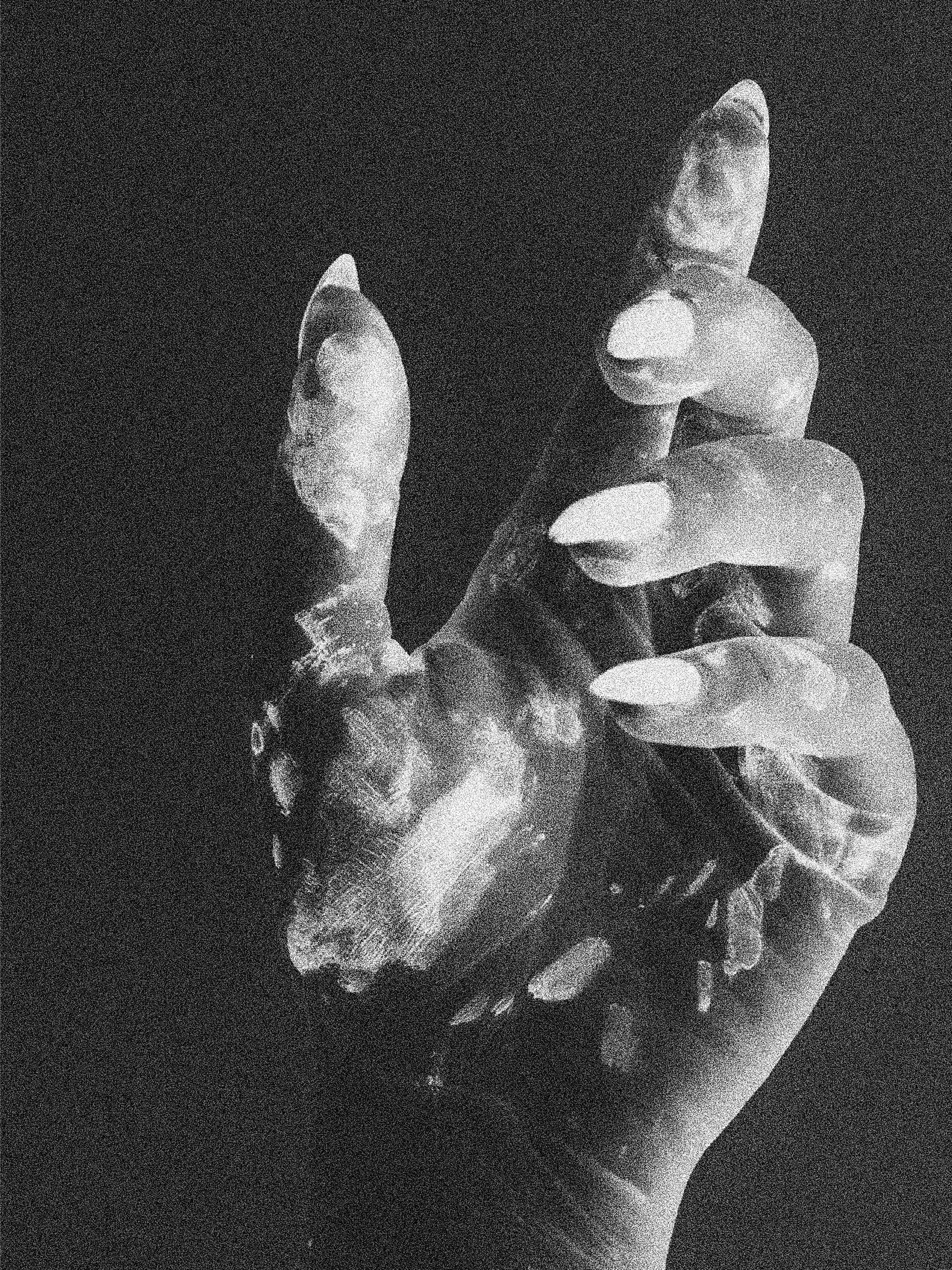 A black and white photo of a woman holding a handgun, with a pressed and serious expression.