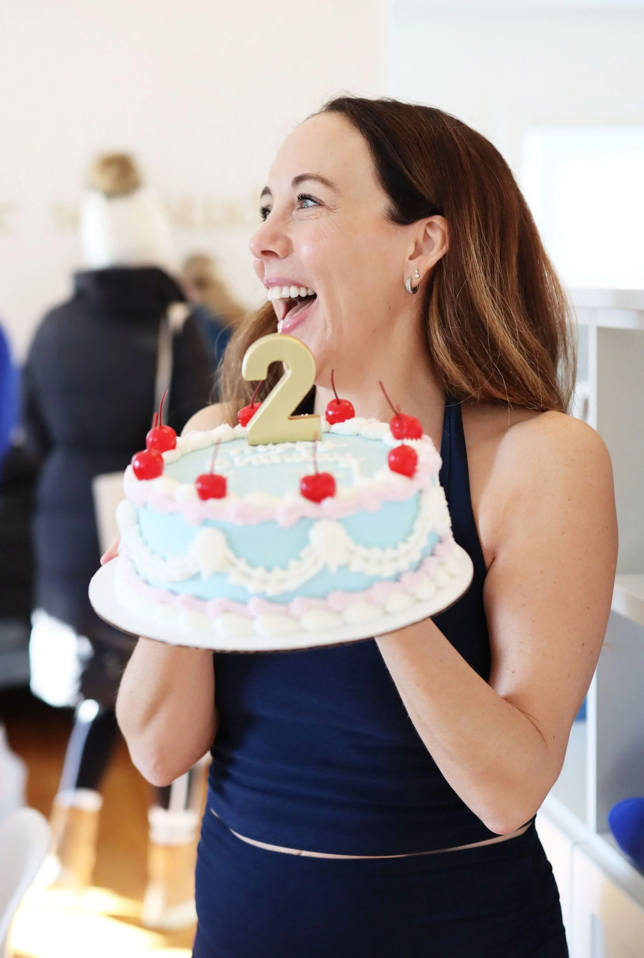 woman holding a celebratory cake