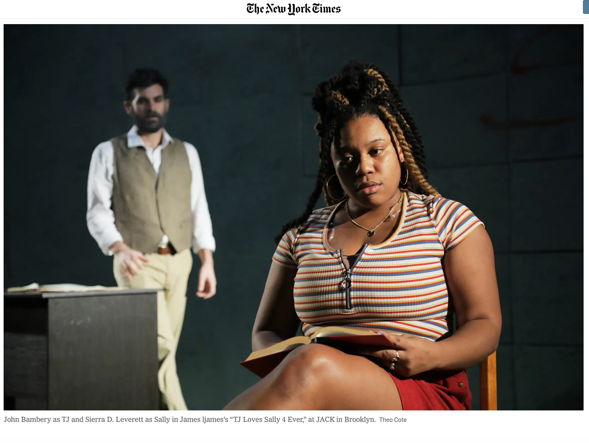 A scene from the play 'TJ Loves Sally 4 Ever' showing a woman with braided hair, earrings, a striped t-shirt, and red shorts sitting on a chair reading a book. Behind her, a man with dark hair, beard, wearing a beige vest over a white shirt and beige