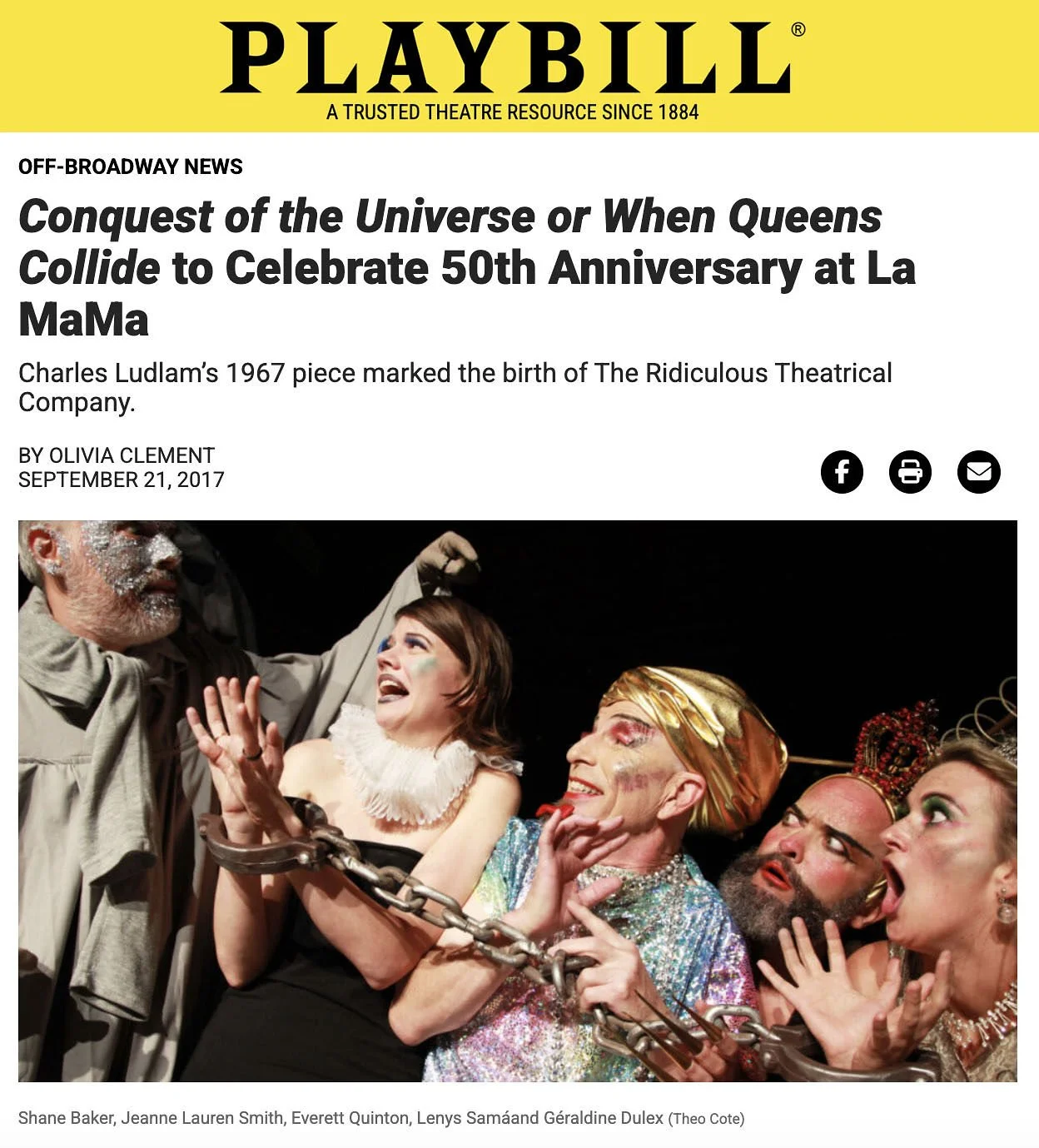 Actors on stage in theatrical costumes and makeup, with some holding a chain, portraying a dramatic scene.