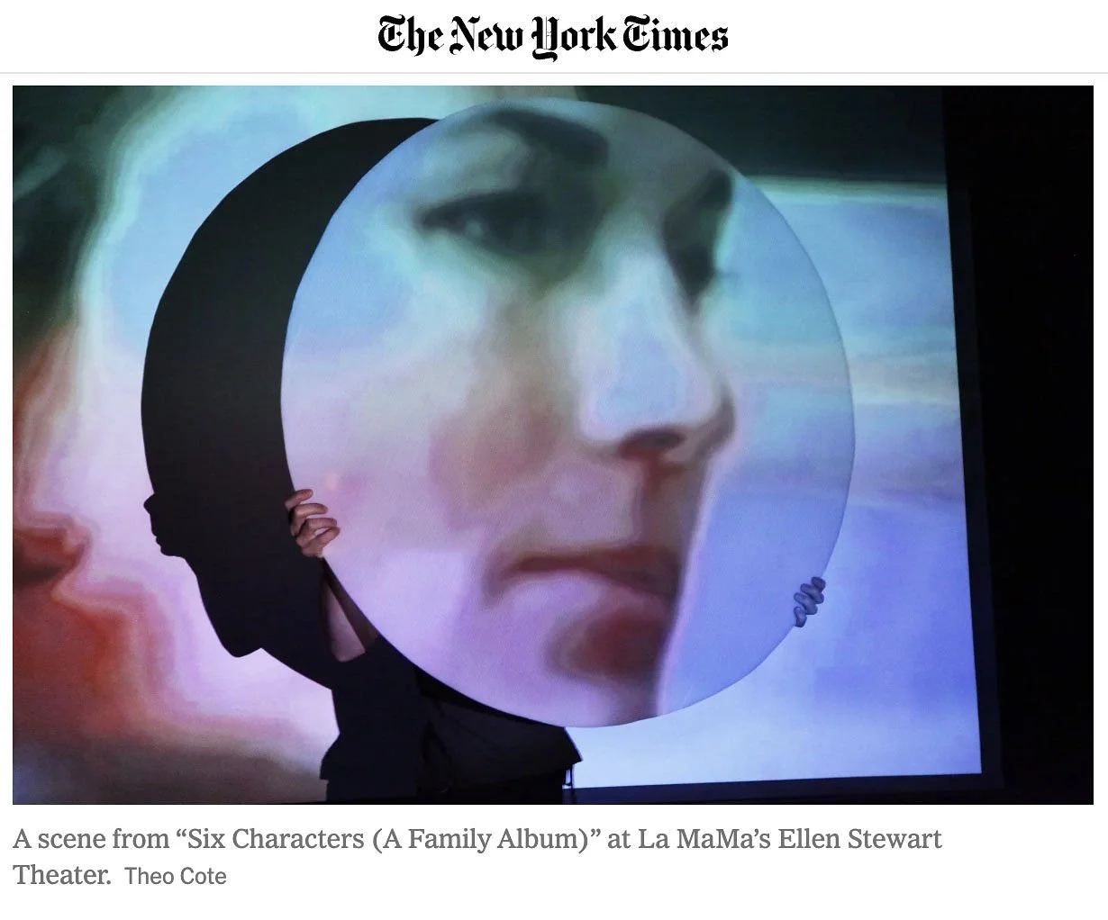 A person holding a circular display with a large close-up face of a woman, showing her eyes, nose, and lips, with blurred colors in the background.