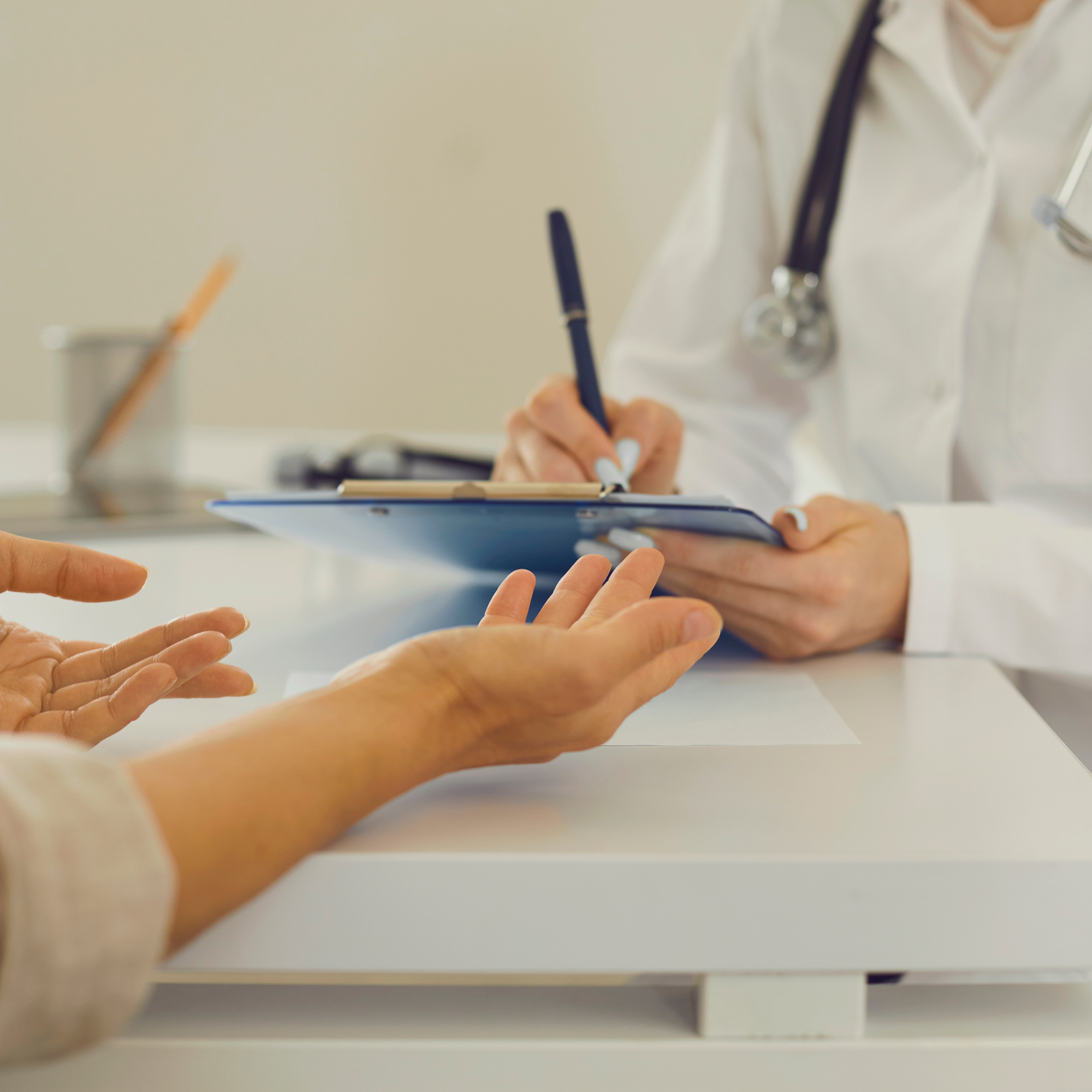 Healthcare professional reviewing information with a patient during a consultation.