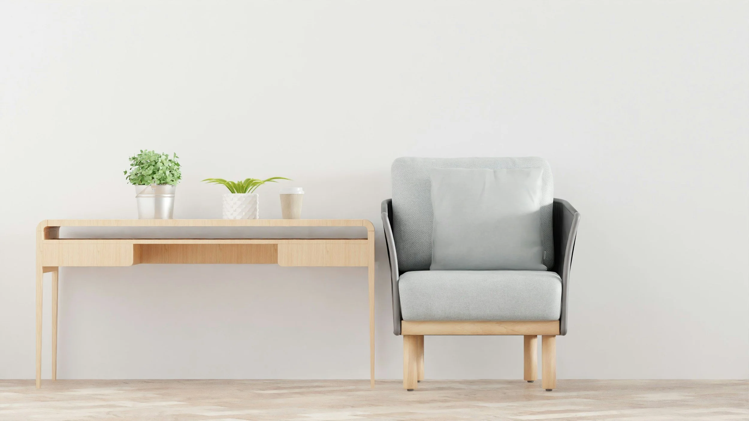 Une salle avec deux plantes en pots sur une table en bois, à côté d'un fauteuil gris clair avec un coussin blanc.