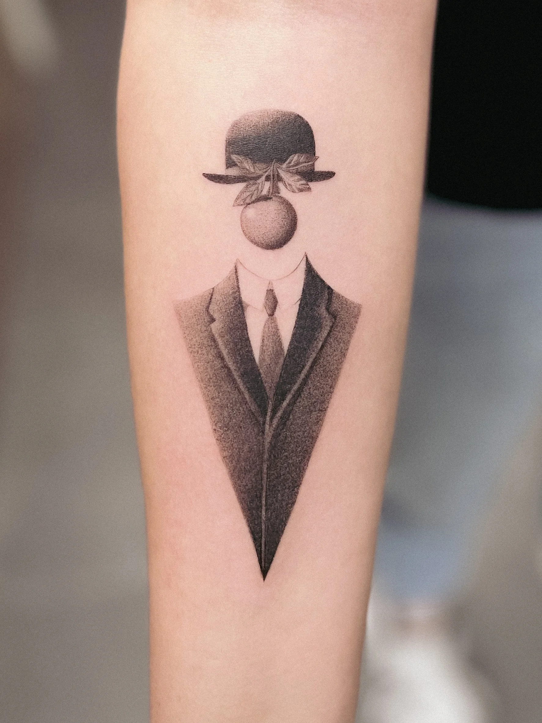 magritte man apple tattoo