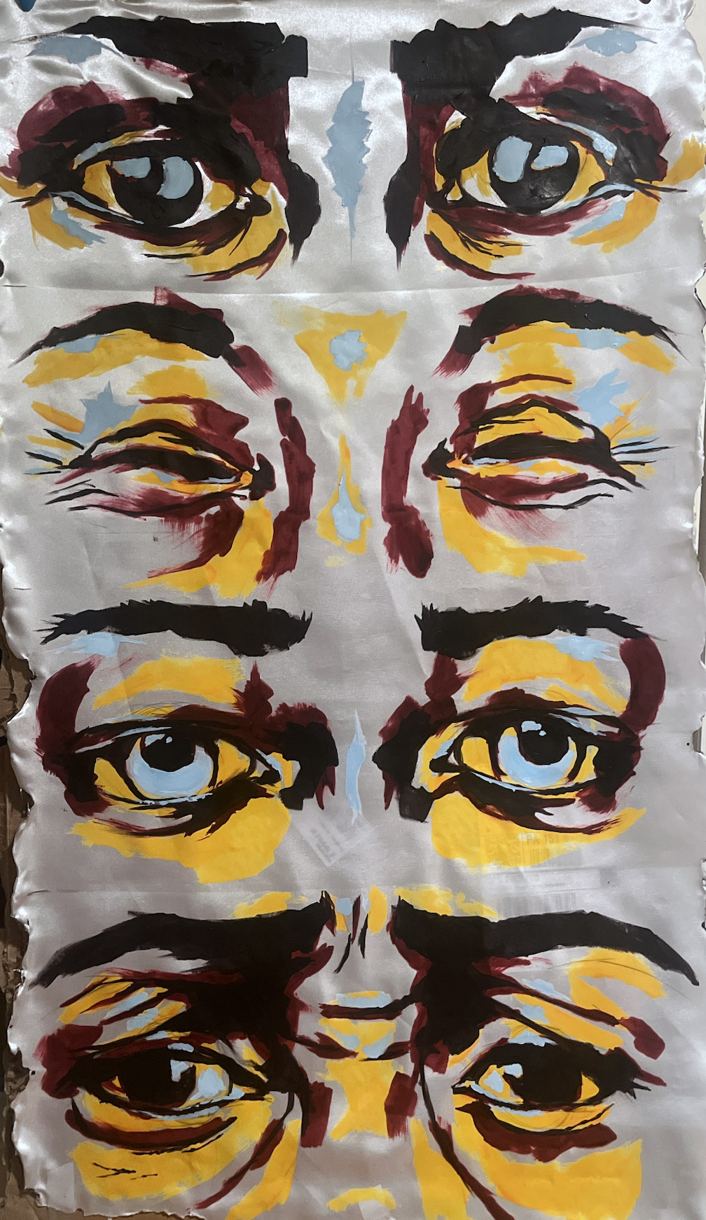 A colorful abstract painting of multiple human eyes and eyebrows on a silver metallic background, painted with bold black, yellow, red, and light blue brushstrokes.