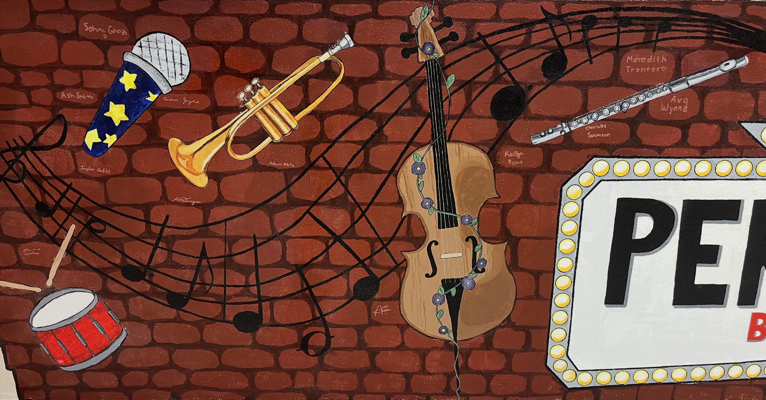 Colorful mural of musical instruments on a brick wall, including a microphone with star pattern, a trumpet, a violin with flowers, a tambourine, and a part of a sign with illuminated border.