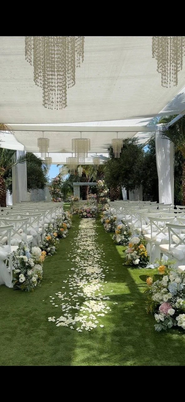 Outdoor wedding ceremony at Cristalli di Sale surrounded by olive trees in Puglia, Italy.