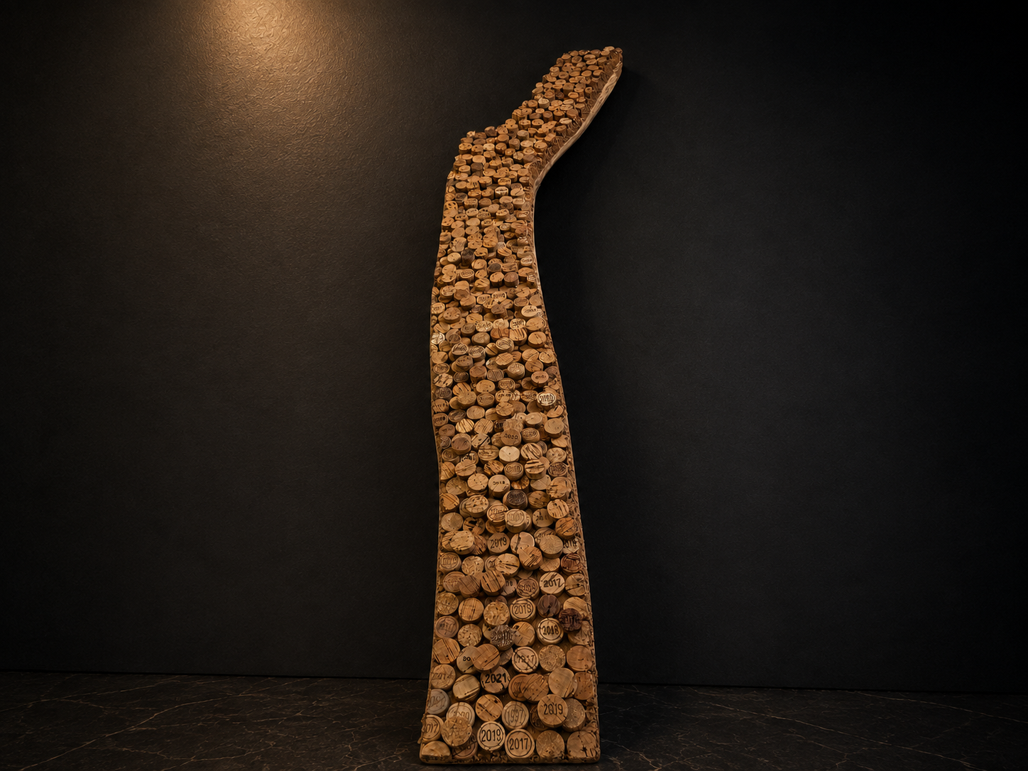 SELECTED WORK

VINTAGES OF TIME

2024

MATERIAL
Smoked oak and approximately 1,400 hand-cut recycled wine cork discs

DIMENSIONS
145 × 13–22 × 5 cm

EDITION / STATUS
Unique work / Available

DESCRIPTION
Vintages of Time gathers approximately 1,400 re