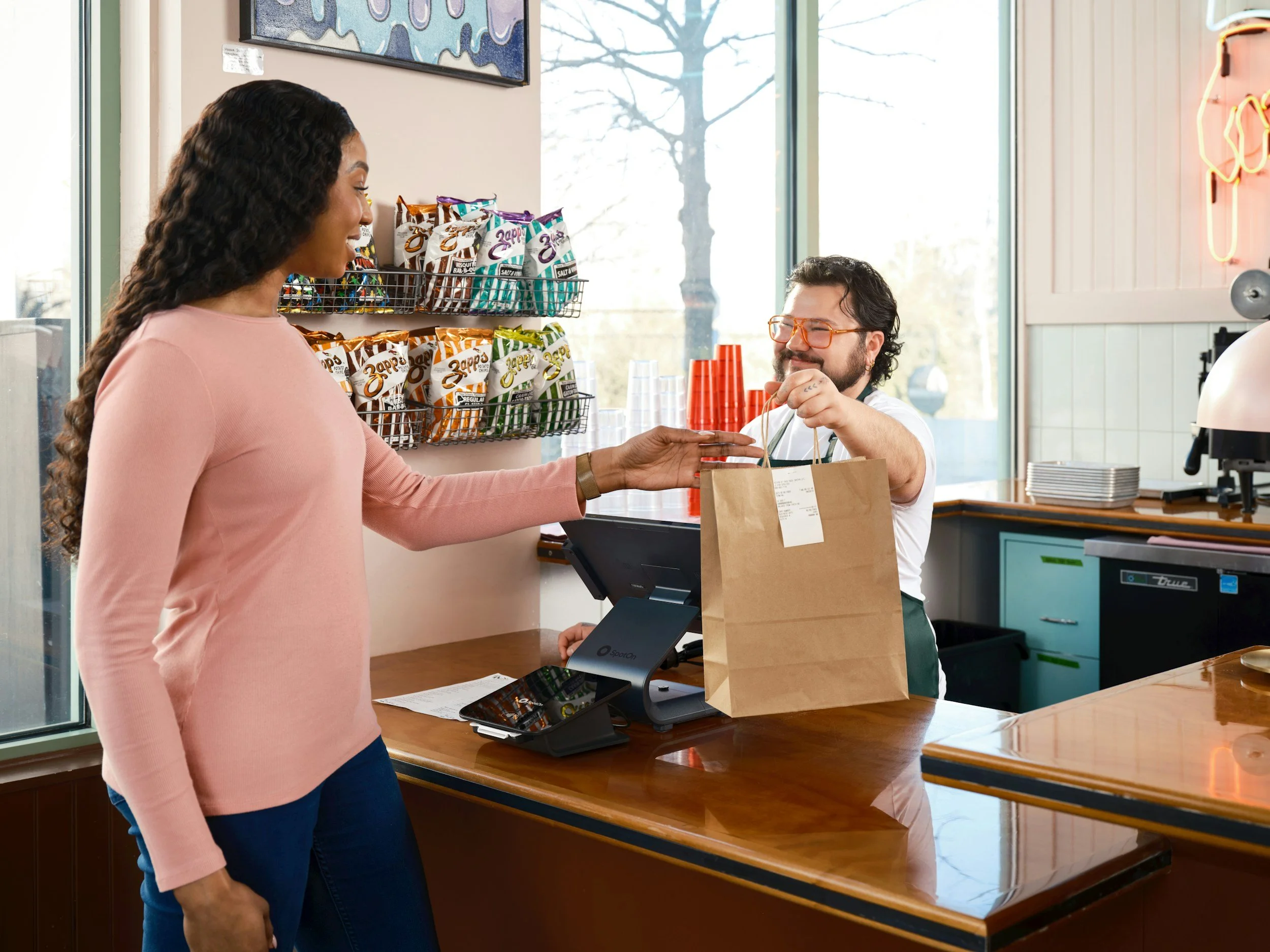 Retail employee assisting a customer in a local store.