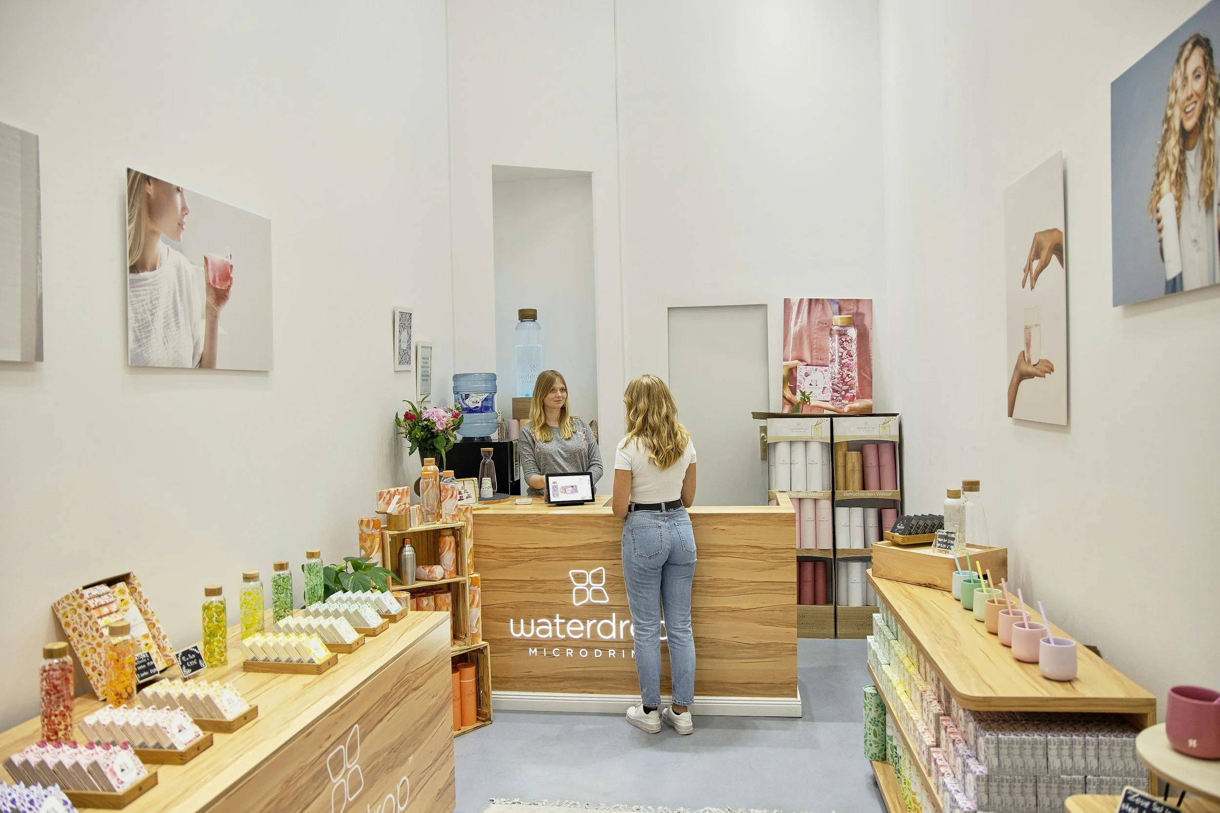 Retail employee assisting customers in a local business.