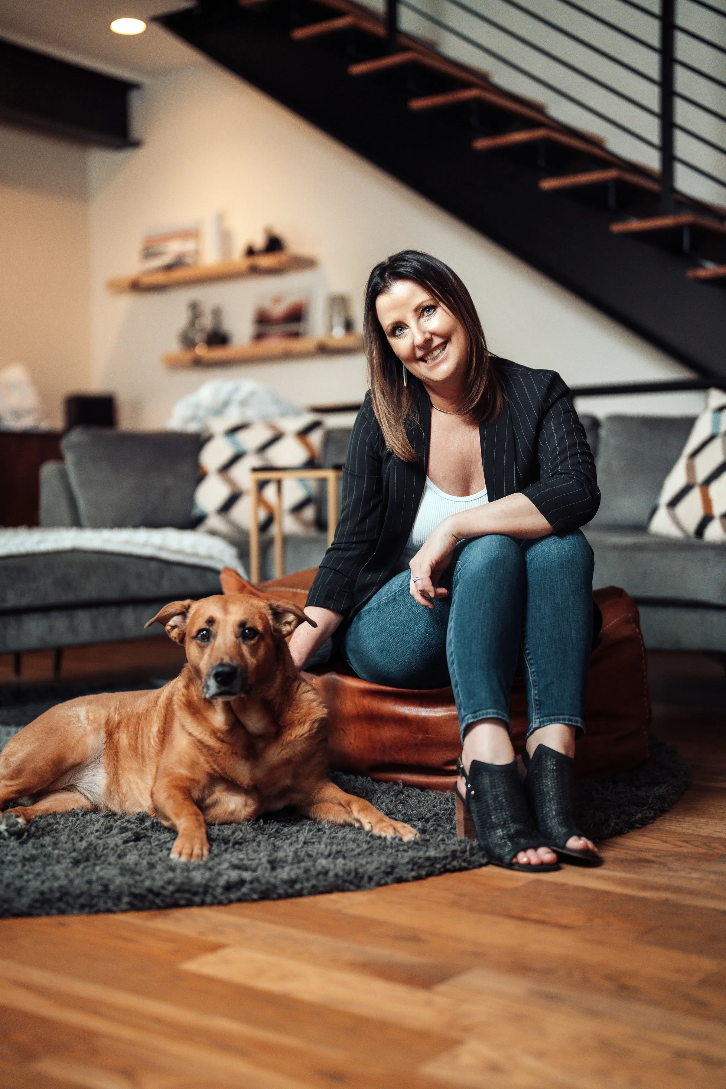 Misty Vogel sitting with her rescue dog in therapy office