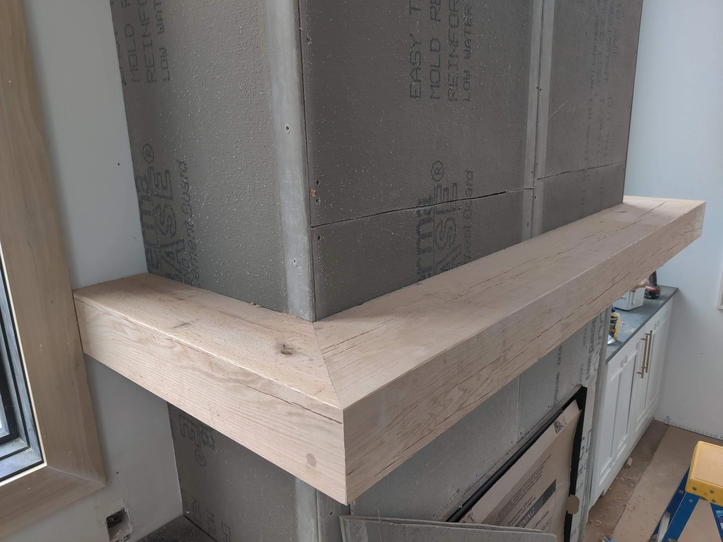 Close-up of a mitered corner on the custom wood mantel