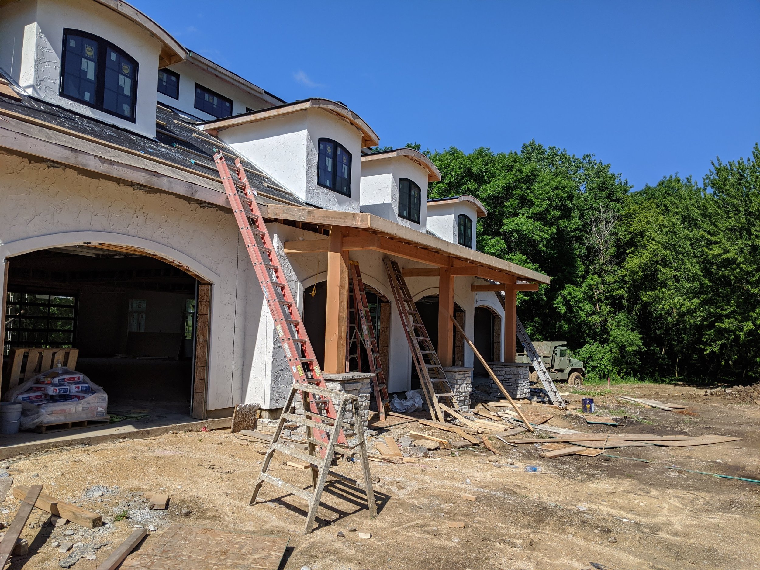 Timber-frame front porch on a custom stucco home