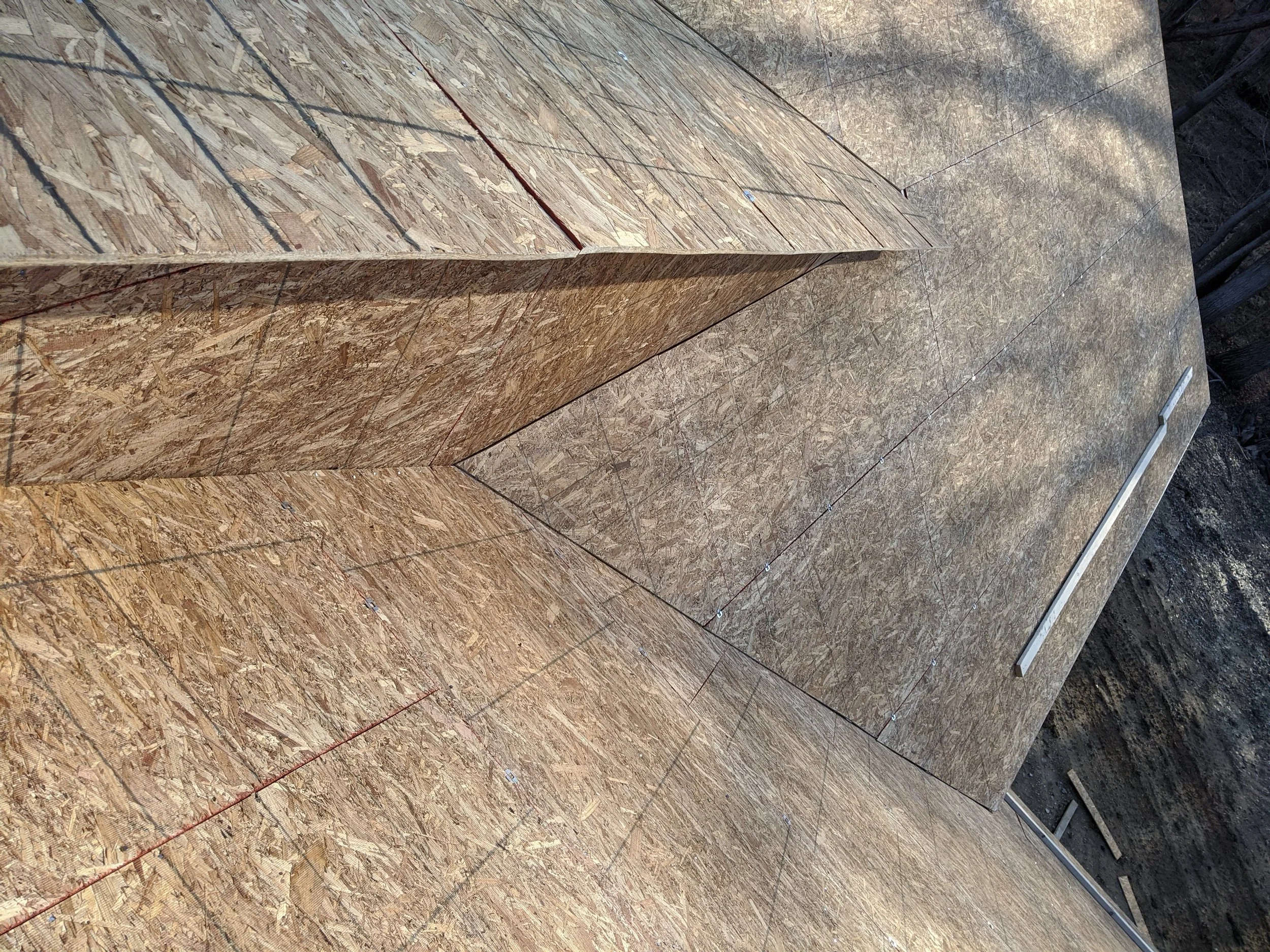 Tight roof sheathing where two roof planes meet in a complex valley
