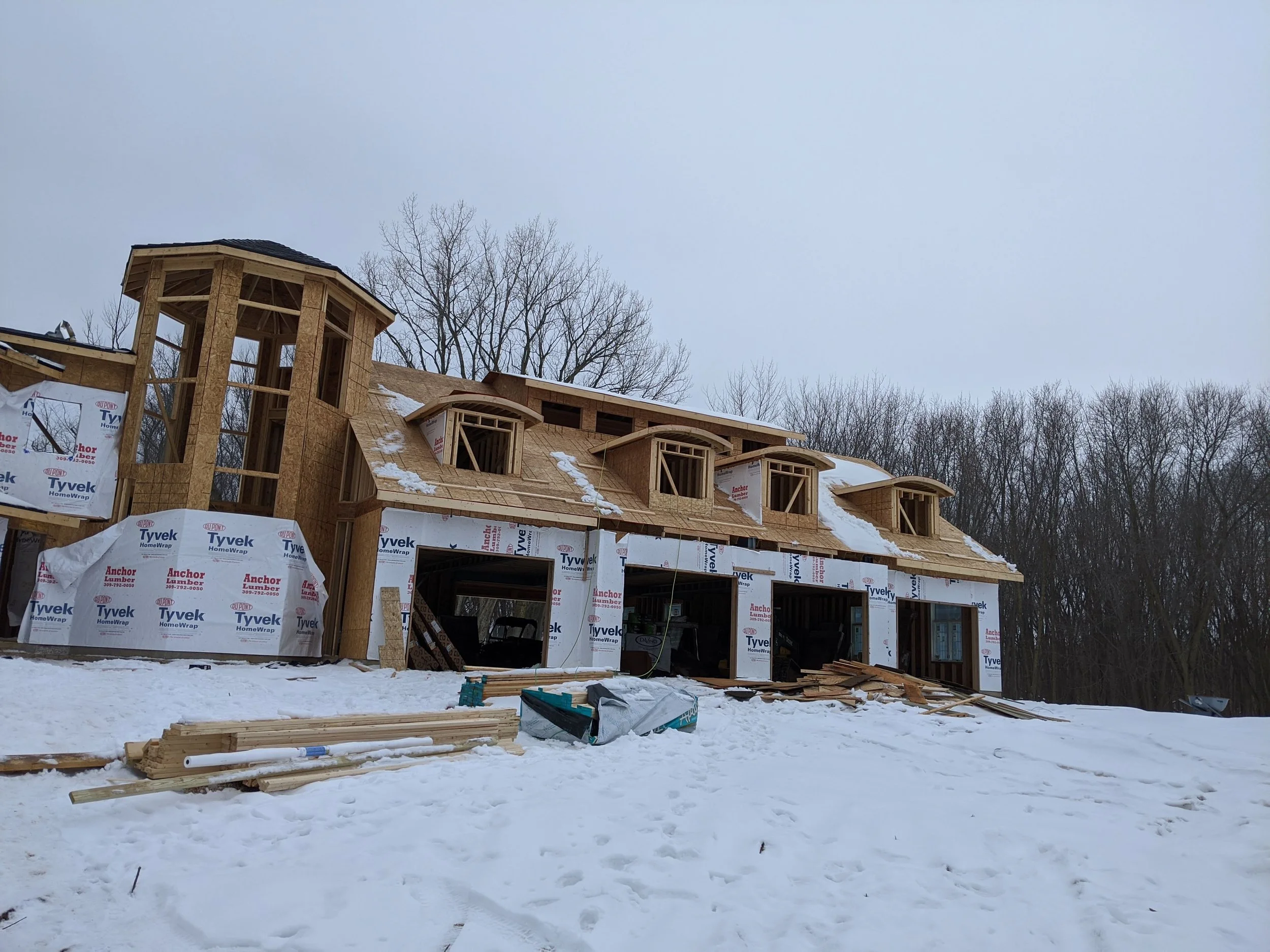 Barrel dormers framed and sheathed in winter