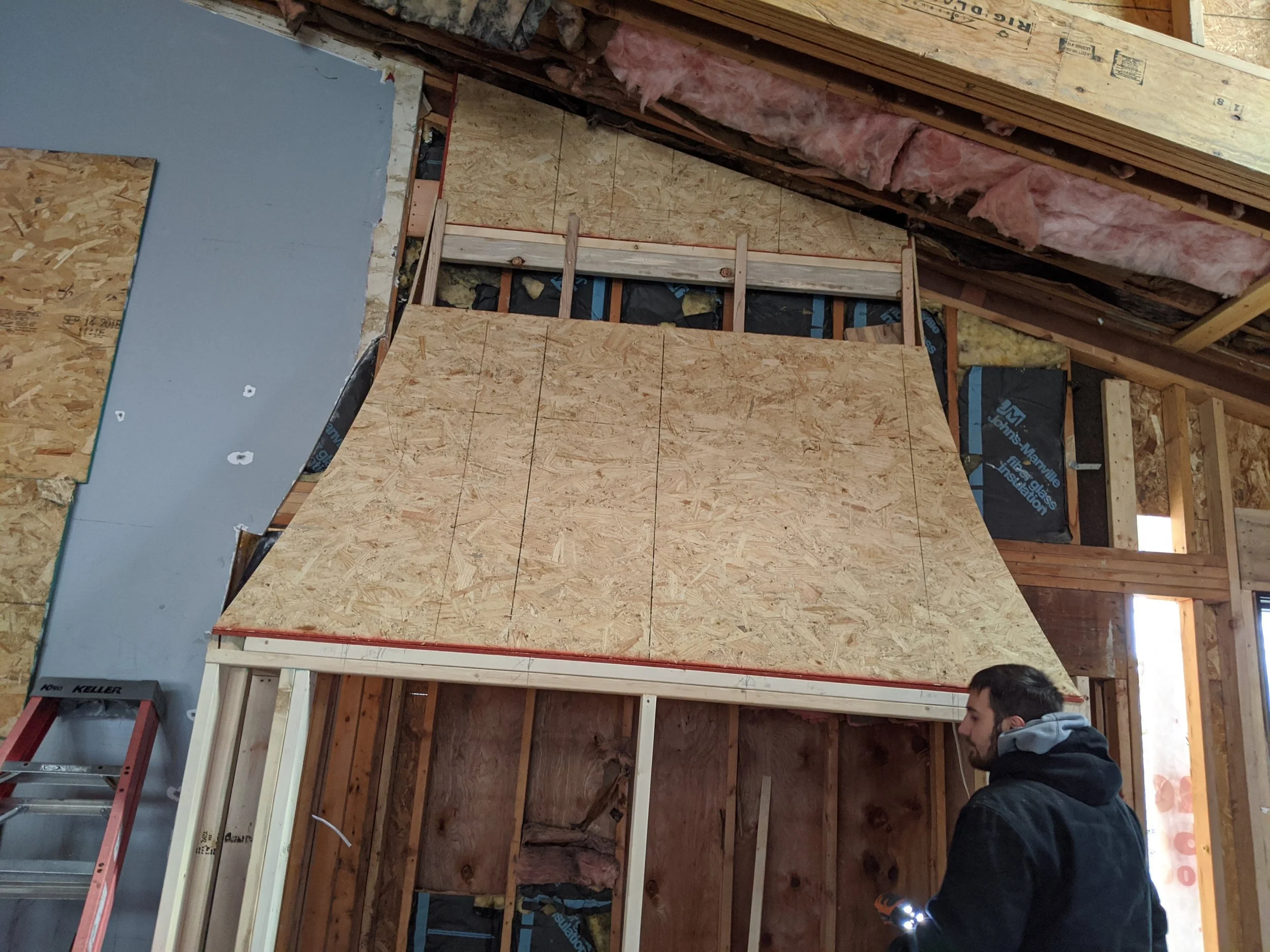 Curved range hood framing in a custom kitchen