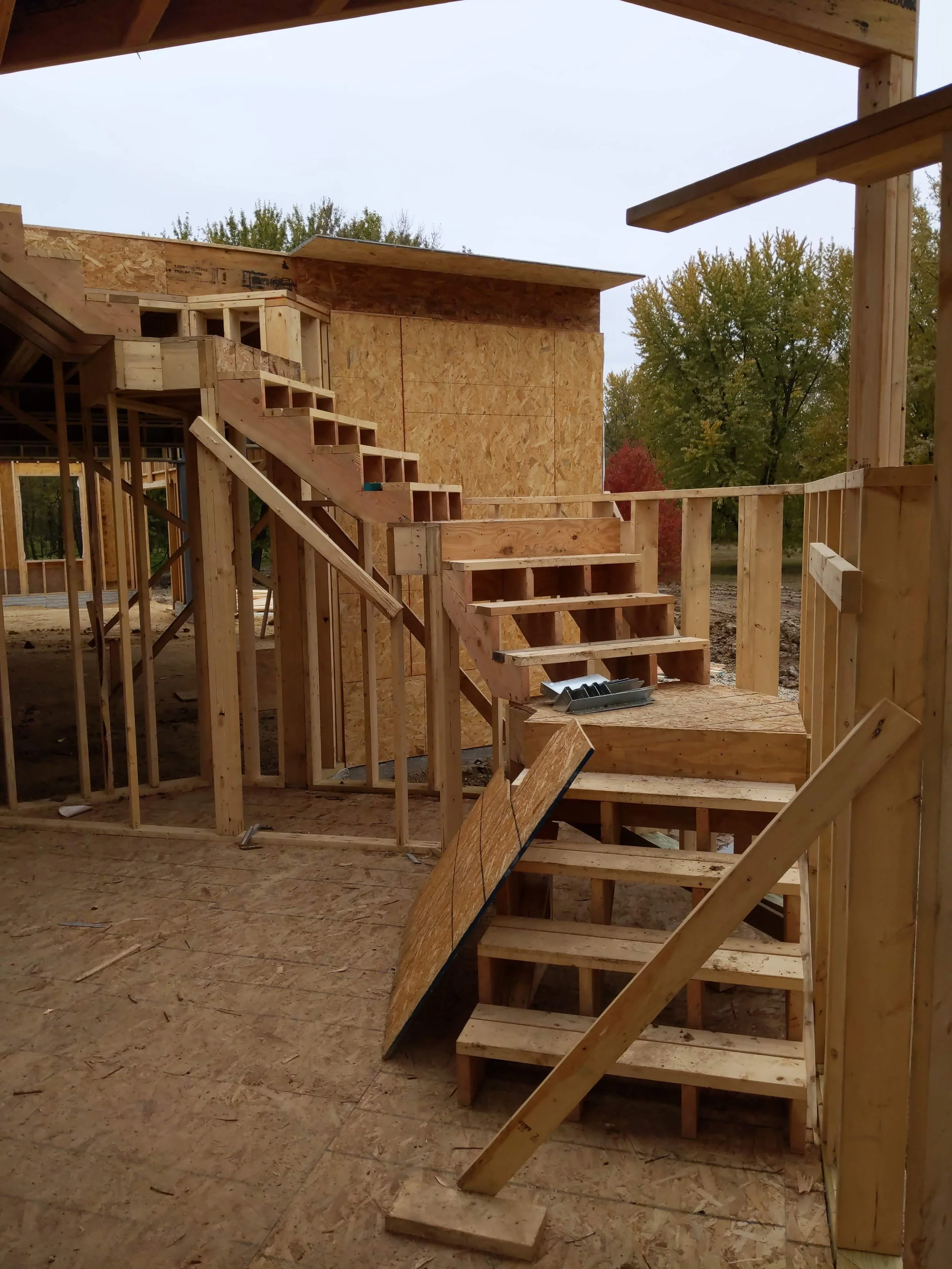 Four-run framed stair with switchback landings, redesigned on site when the floor height came in over 11 feet instead of the 10 feet the architect originally planned for.