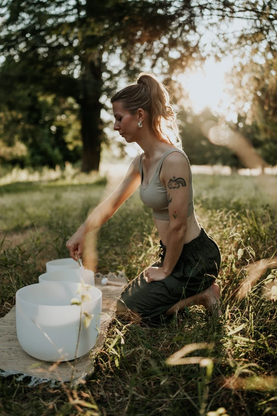 Solara Flow with Iz sound bath facilitator creating a calming sound bath experience with crystal singing bowls