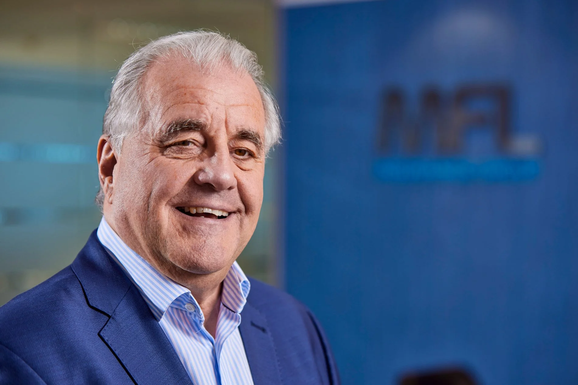 Professional corporate headshot of a director in a Manchester office