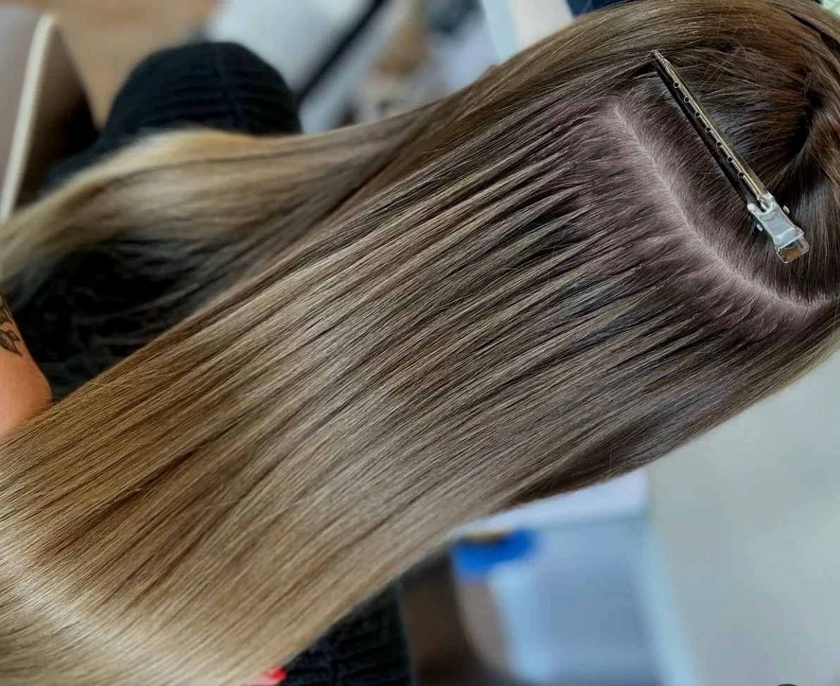 Close-up of a woman with long, straight, blonde hair secured with a hair clip.