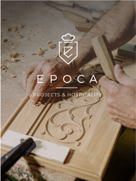 Close-up of a person carving wood with detailed floral patterns using hand tools in a woodworking shop.