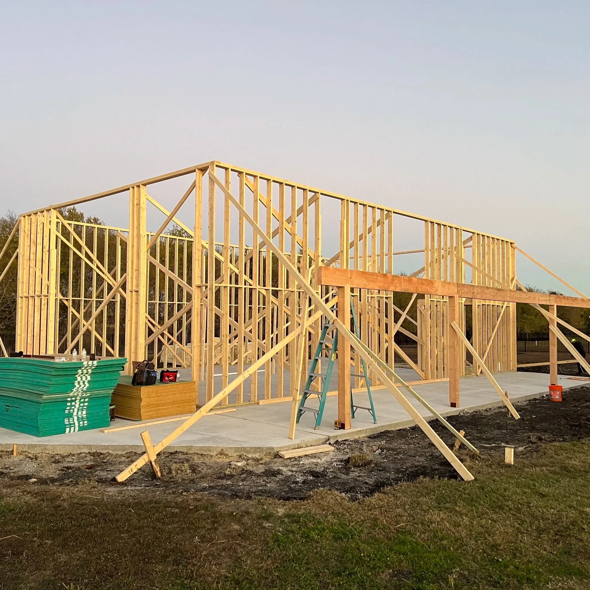 Construction progress drone photo of wood framing going up on a new slab, aerial construction documentation
