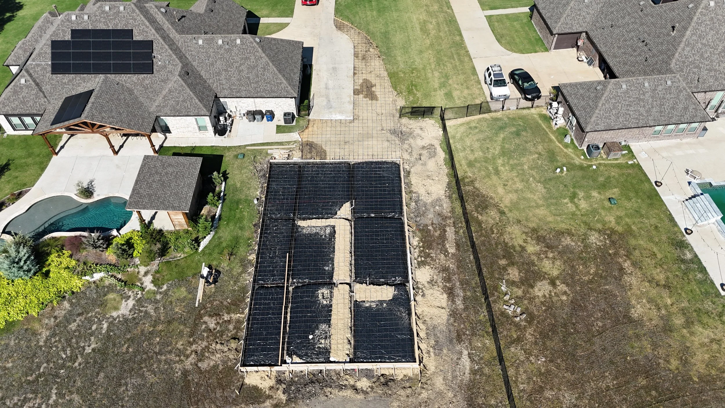Top-down drone photo of a residential foundation with rebar and vapor barrier before the pour in Rockwall, TX