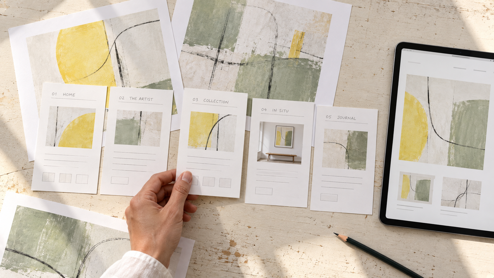 AI-generated process illustration: overhead view of printed website layouts and a tablet, arranging an artist’s work into a coherent online story.