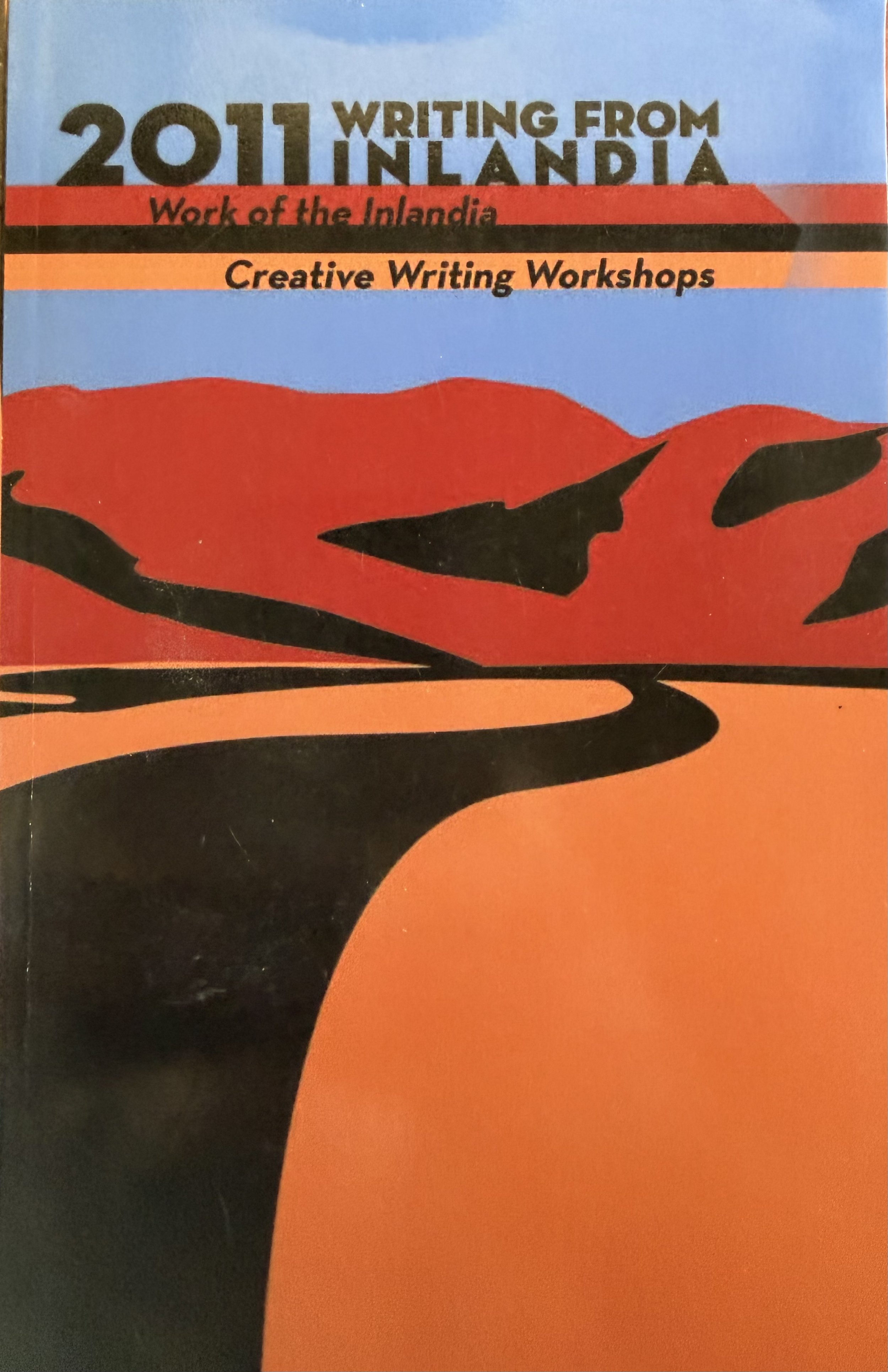Book cover titled '2011 Writing from Inlandia' with a landscape illustration of red mountains, black river, and orange foreground.