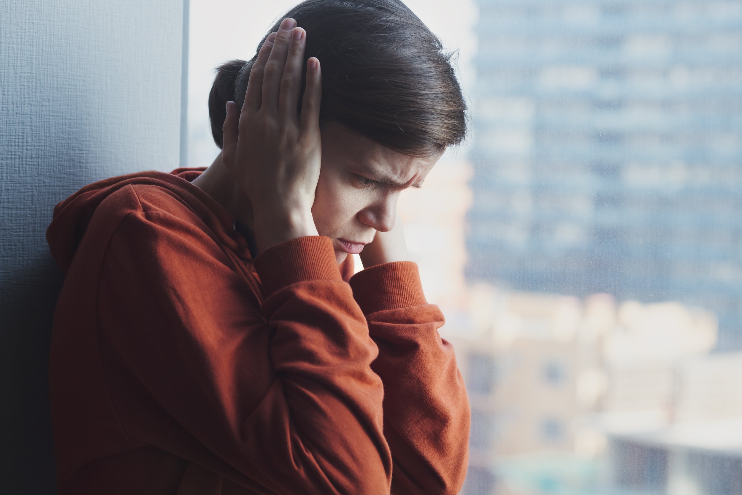 Woman experiencing autistic burnout after years of masking, one of the most common reasons late-diagnosed adults seek an assessment.