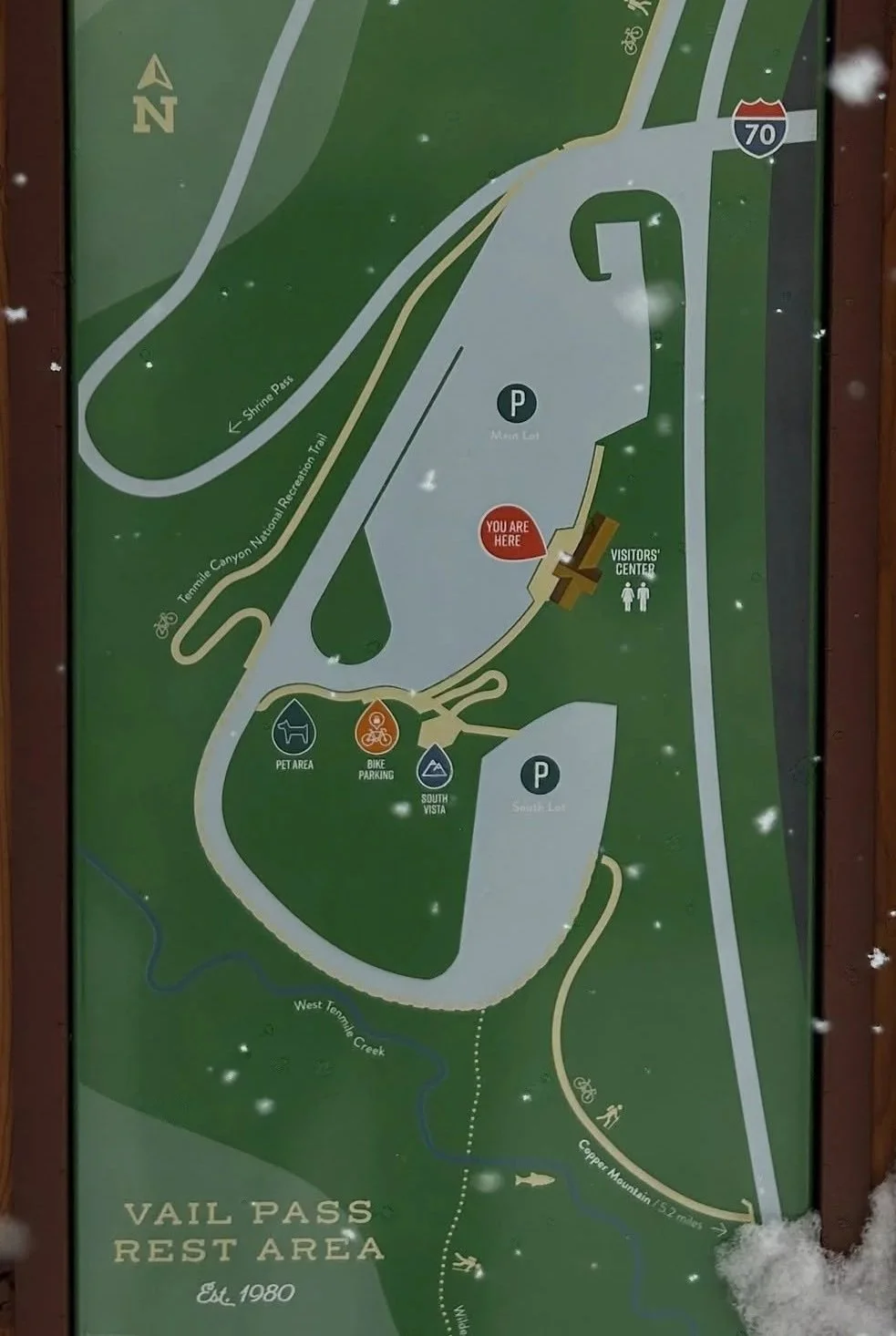 Map of Vail Pass Rest Area showing parking lots, a visitor’s center, bike parking, pet area, trails, a creek, and the surrounding landscape.
