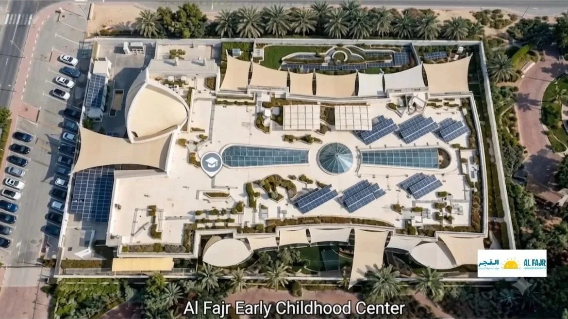 Aerial view of Al Fajr Early Childhood Center with rooftop solar panels and landscaping, surrounded by landscaped areas and parking lot.
