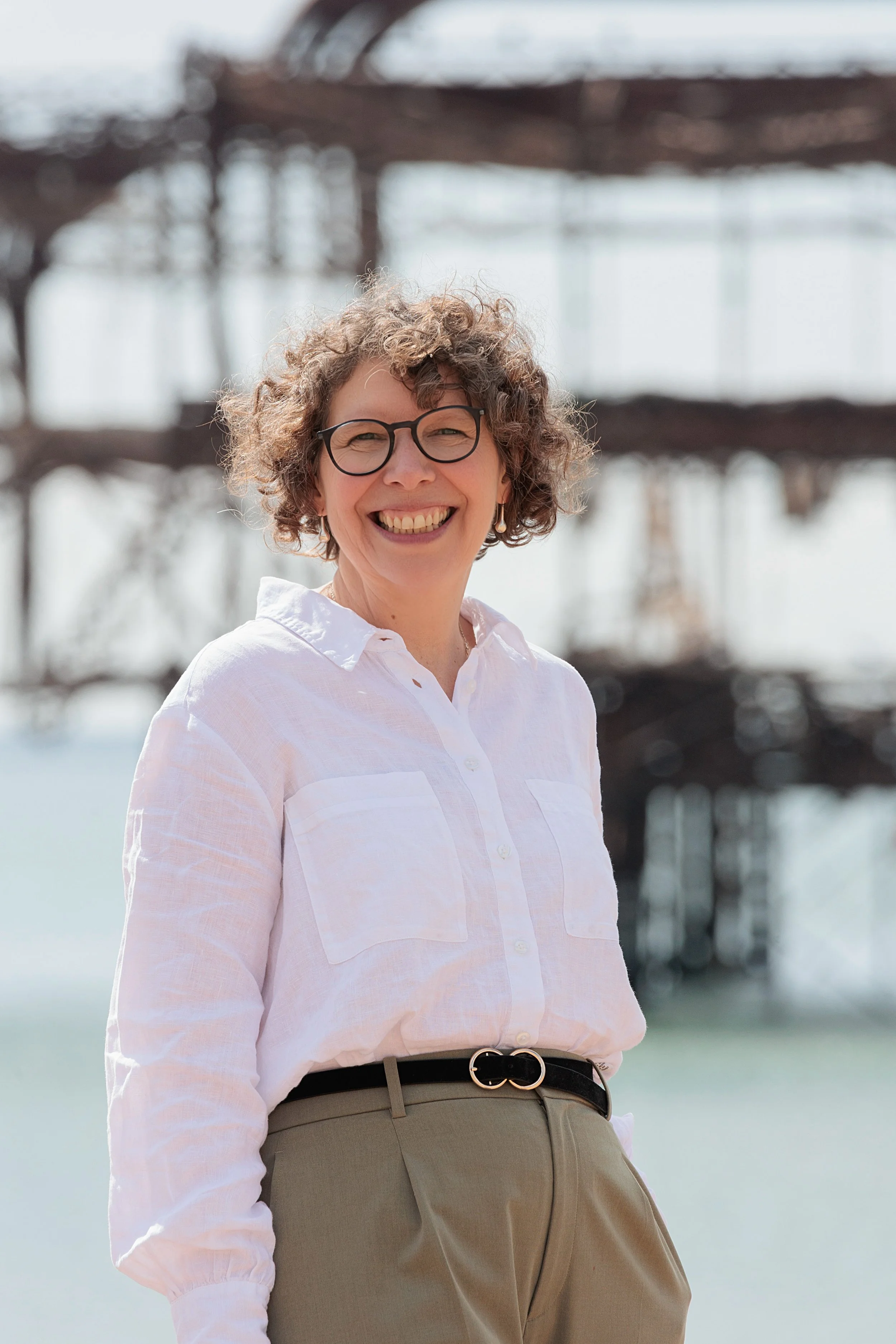 Woman smiling against out of focus backdrop of West Pier